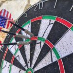 Darts board with darts arrows