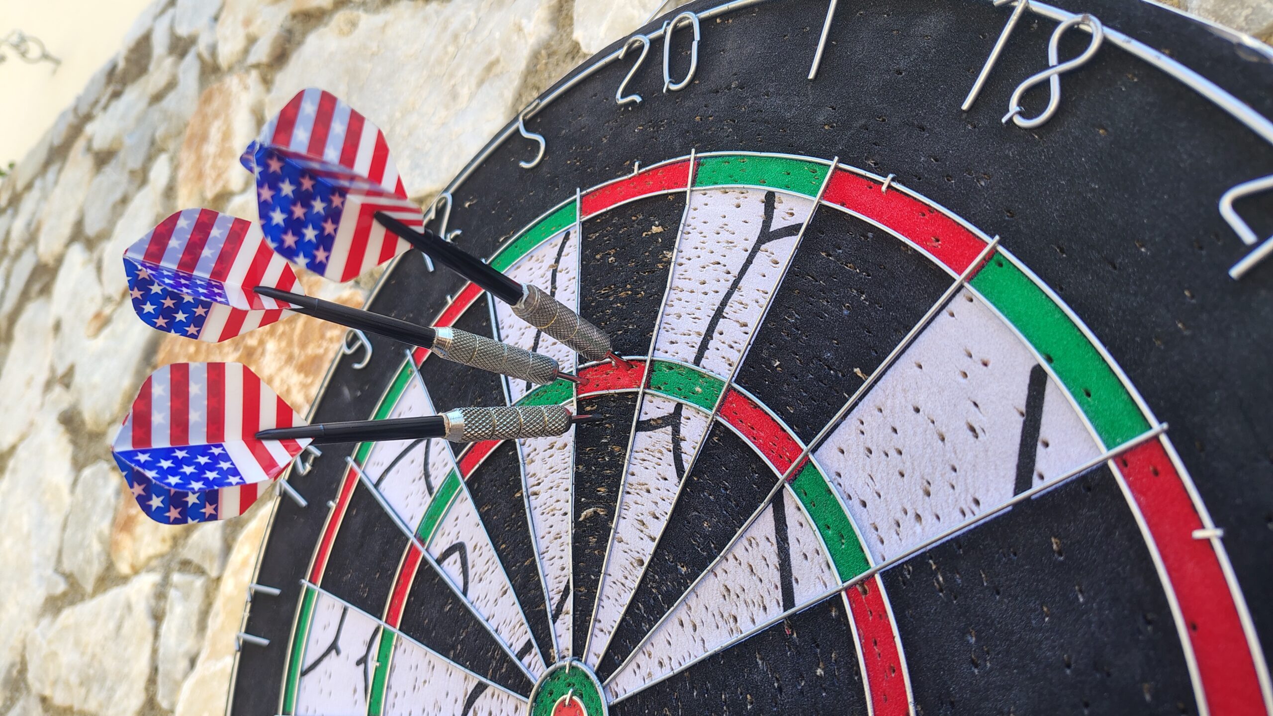 Darts board with darts arrows